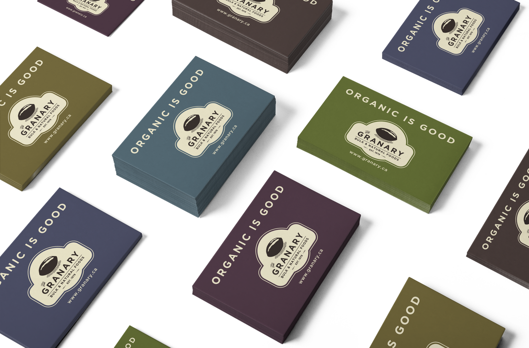 Design mock-up of The Granary business cards in five different colour options, presented as stacks of cards on a horizontal surface.