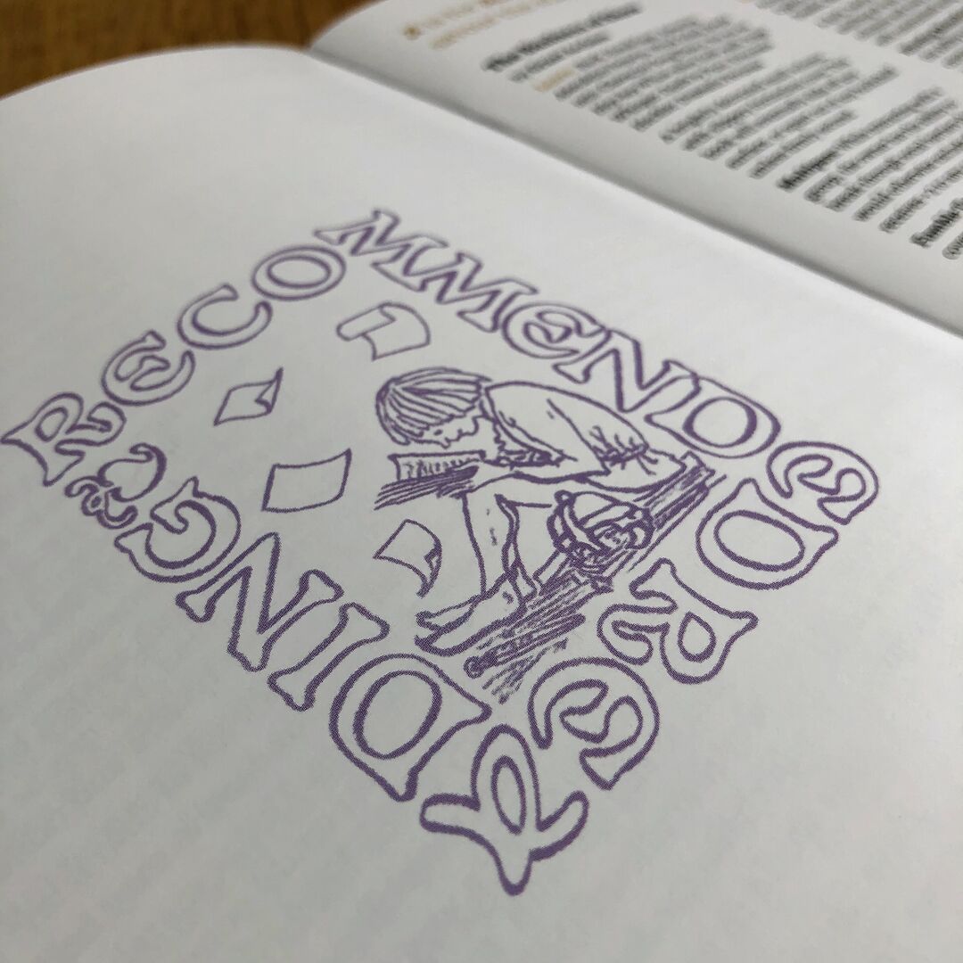 Open page of "Wayward Words" zine showing a illustration of a young person reading amongst falling papers. Letters form a frame around the figure and read "Recommended Reading".