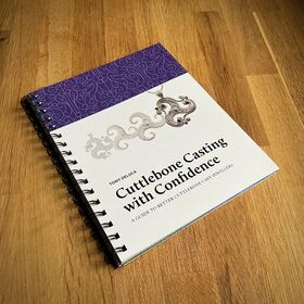 The book "Cuttlebone Casting with Confidence" is placed on a wooden surface.