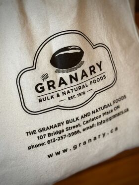 "The Granary" logo and contact details printed  on a natural cloth shopping bag with dark brown text.
